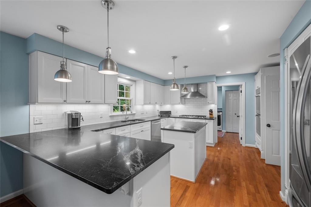 1014 Osage Road Pittsburgh, PA 15243 - Photo 17 of 49 a kitchen with stainless steel appliances granite countertop a sink a stove and a refrigerator
