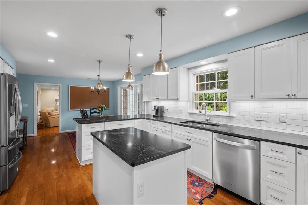 1014 Osage Road Pittsburgh, PA 15243 - Photo 19 of 49 a kitchen with stainless steel appliances granite countertop a sink a stove and a wooden floors