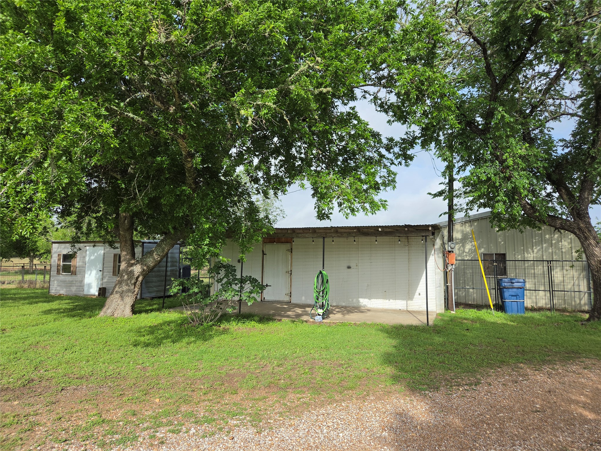 5953 Fm 141 Dime Box, TX 77853 - Photo 17 of 20 a backyard of a house with plants and large tree