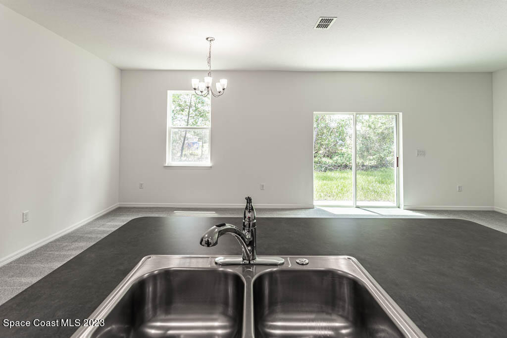 174 Compass Titusville, FL 32796 - Photo 11 of 32 a kitchen that has a sink and a window