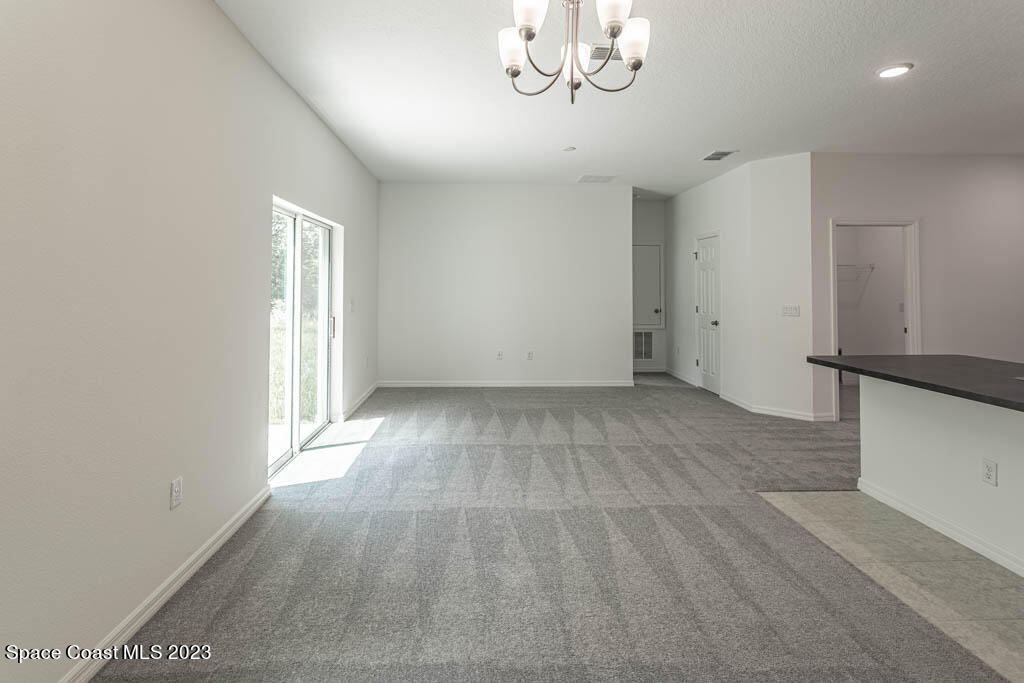 174 Compass Titusville, FL 32796 - Photo 15 of 32 wooden floor in an empty room with a window