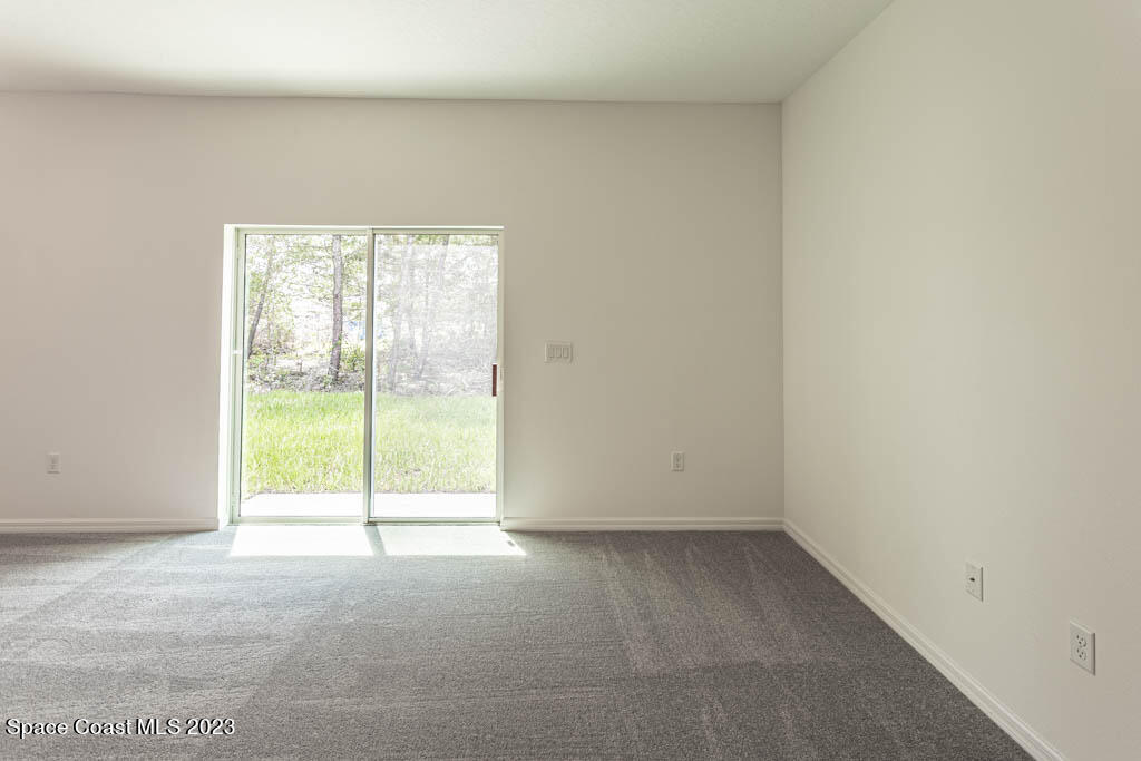 174 Compass Titusville, FL 32796 - Photo 16 of 32 a view of an empty room with a window