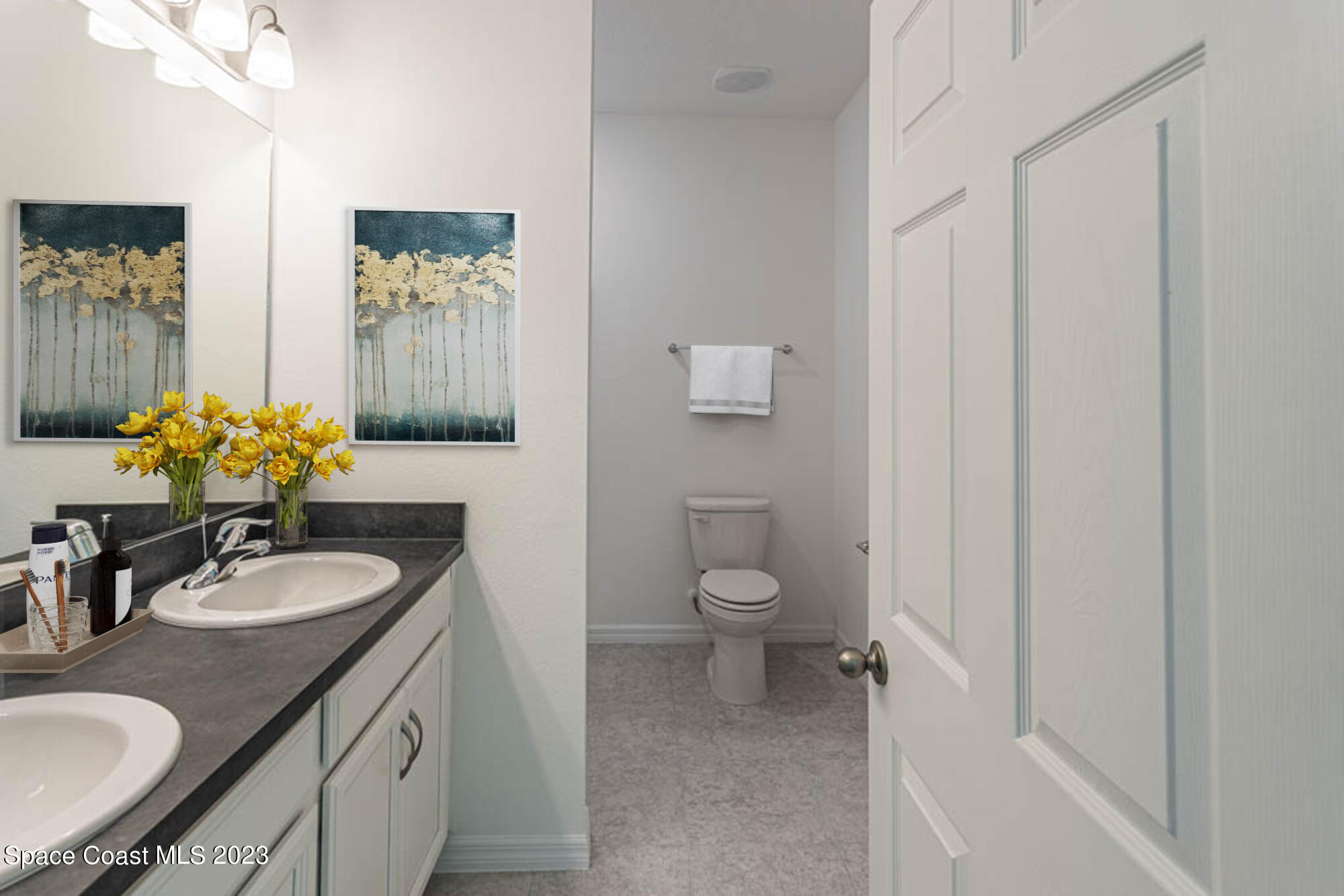 174 Compass Titusville, FL 32796 - Photo 20 of 32 a bathroom with a granite countertop sink vanity mirror and toilet