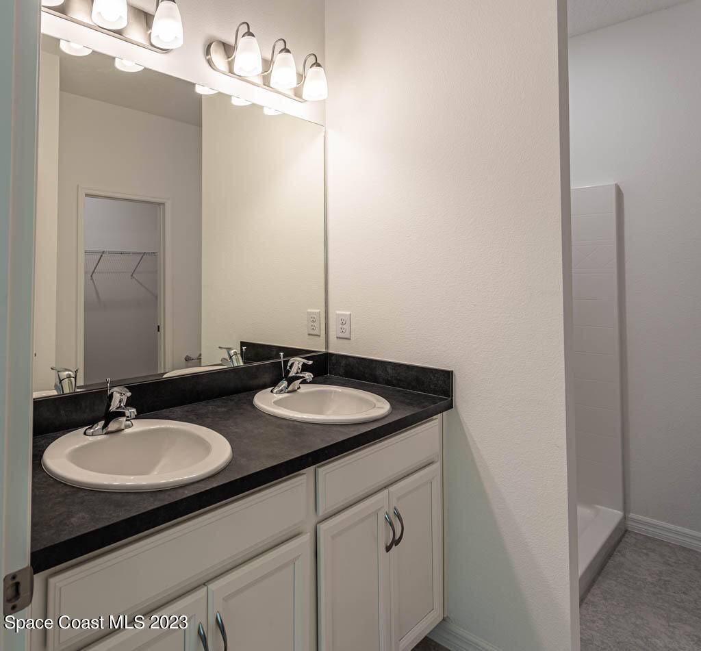 174 Compass Titusville, FL 32796 - Photo 21 of 32 a bathroom with a sink and a mirror