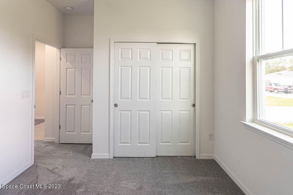 174 Compass Titusville, FL 32796 - Photo 26 of 32 an empty room with windows
