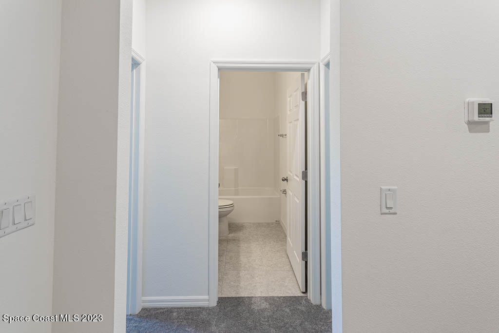 174 Compass Titusville, FL 32796 - Photo 27 of 32 a view of a bathroom from a hallway with toilet