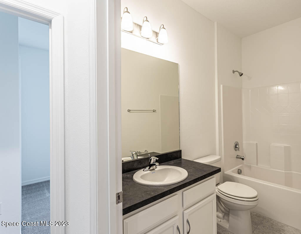 174 Compass Titusville, FL 32796 - Photo 28 of 32 a bathroom with a sink and a mirror