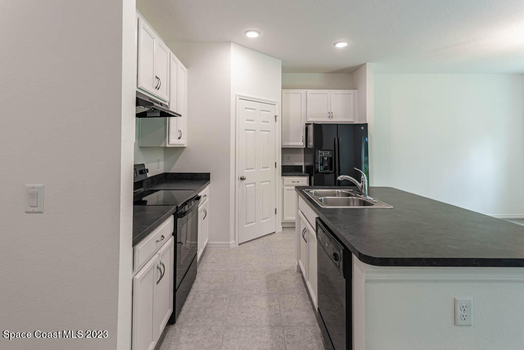 174 Compass Titusville, FL 32796 - Photo 5 of 32 a kitchen with a sink stove and refrigerator
