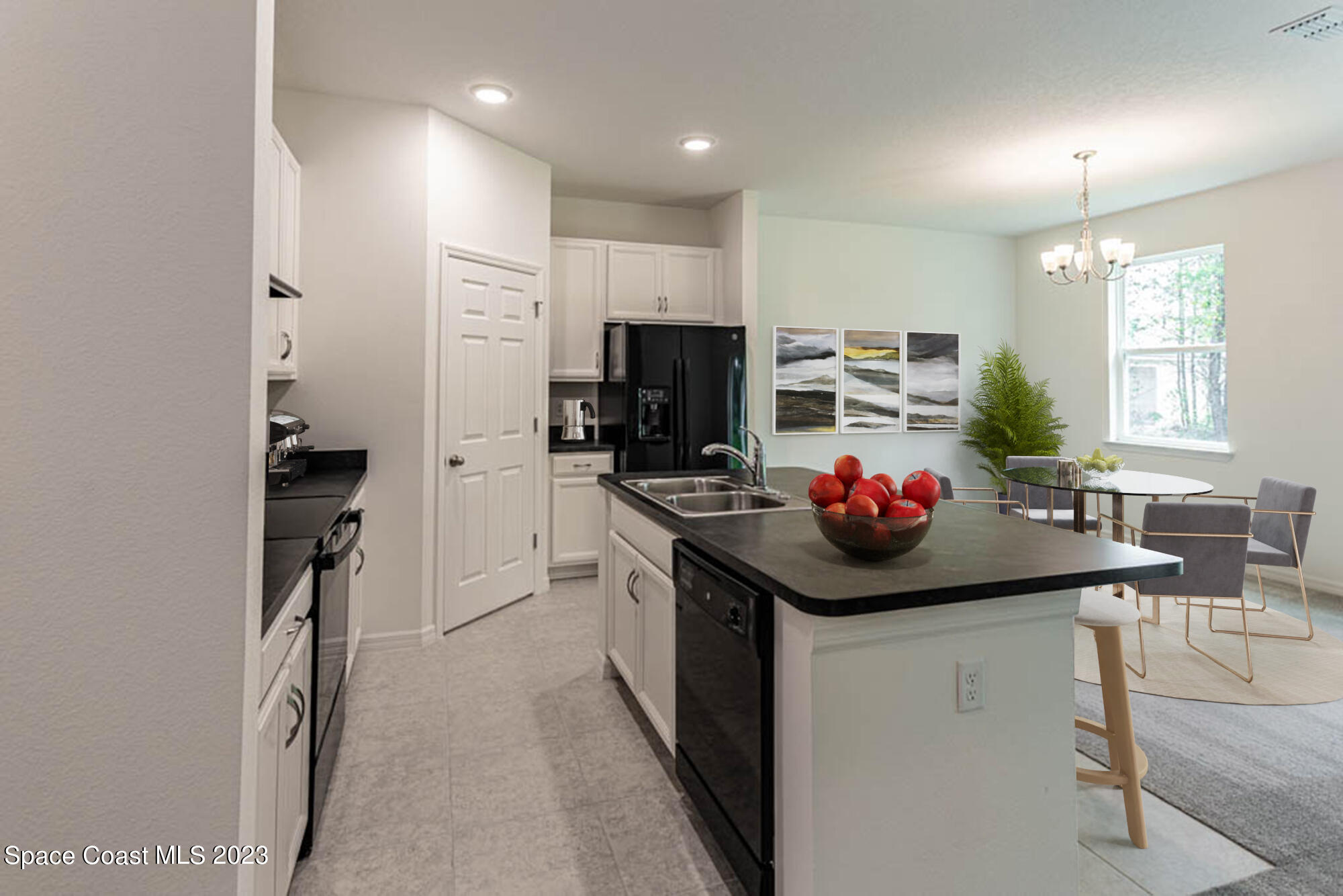 174 Compass Titusville, FL 32796 - Photo 6 of 32 a kitchen that has a sink stainless steel appliances and cabinets