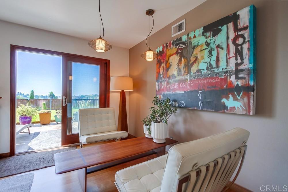 428 Compass Road Oceanside, CA 92054 - Photo 5 of 13 a view of a dining room with furniture one side kitchen view and wooden floor