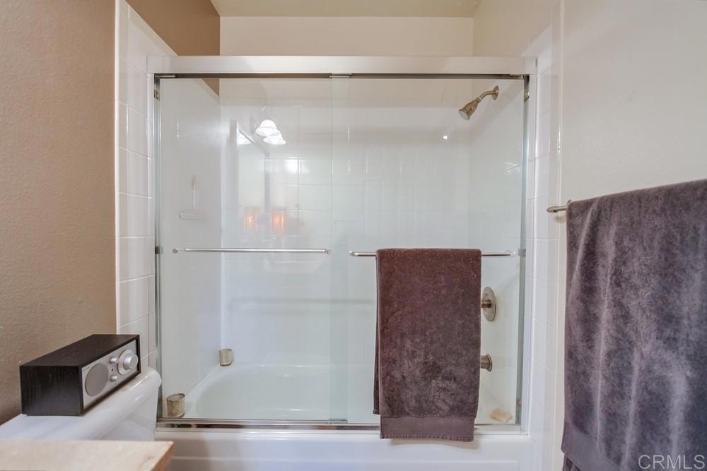 428 Compass Road Oceanside, CA 92054 - Photo 9 of 13 a bathroom with a glass shower door