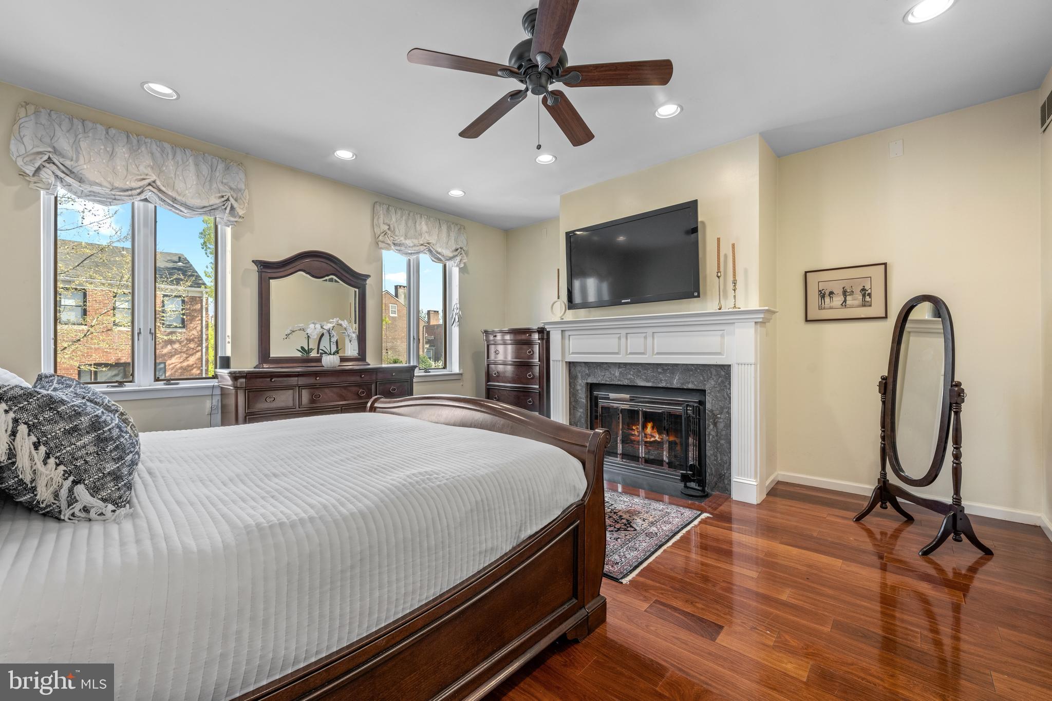303 Spruce Street Philadelphia, PA 19106 - Photo 13 of 30 a bed room with a bed and a fireplace