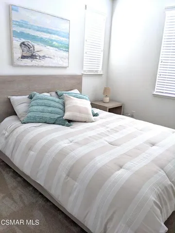 an empty room with windows and ceiling fan