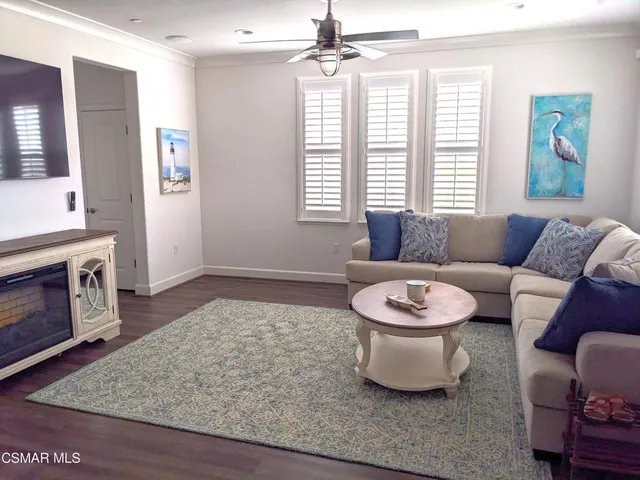a view of a kitchen with wooden floor and cabinets