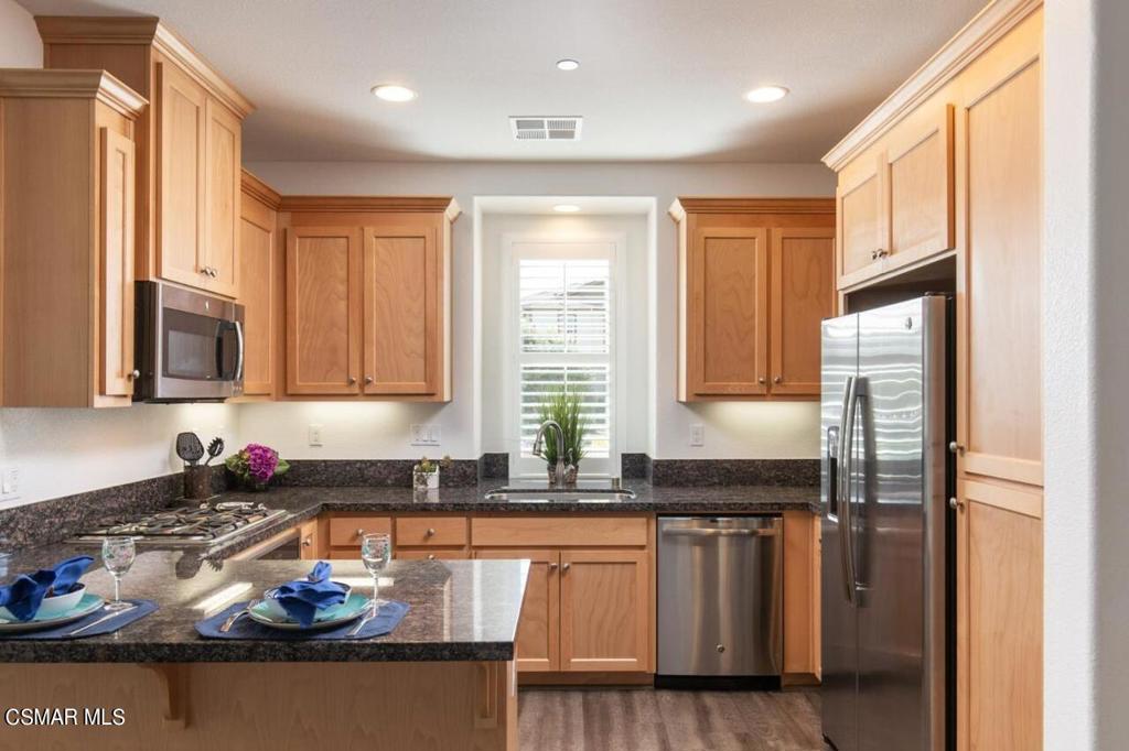 217 9th Street Marina, CA 93933 - Photo 7 of 17 a kitchen with granite countertop a stove a sink and a refrigerator