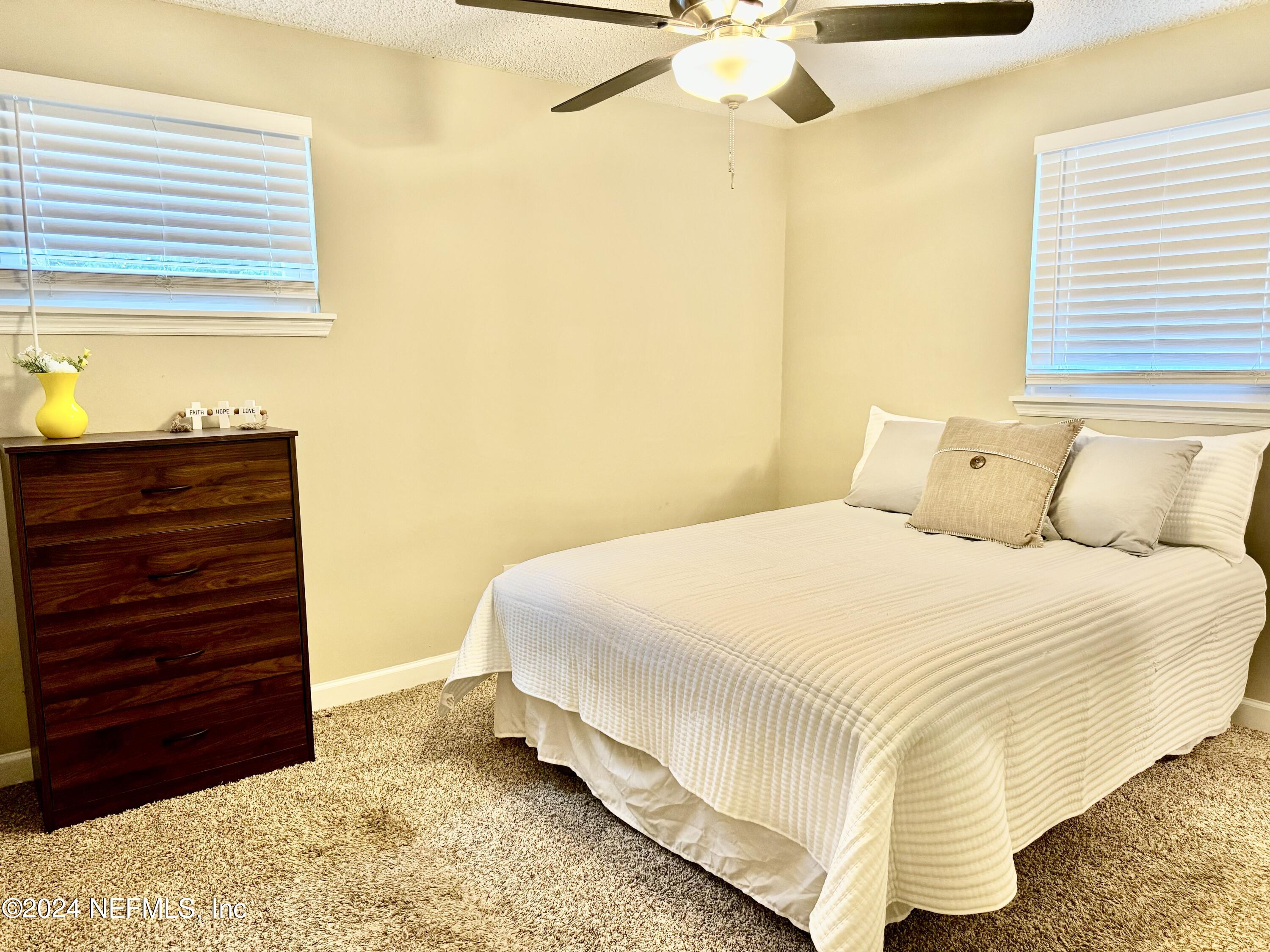 398 Gwinnett Road Orange Park, FL 32073 - Photo 28 of 40 a bedroom with a bed and a dresser