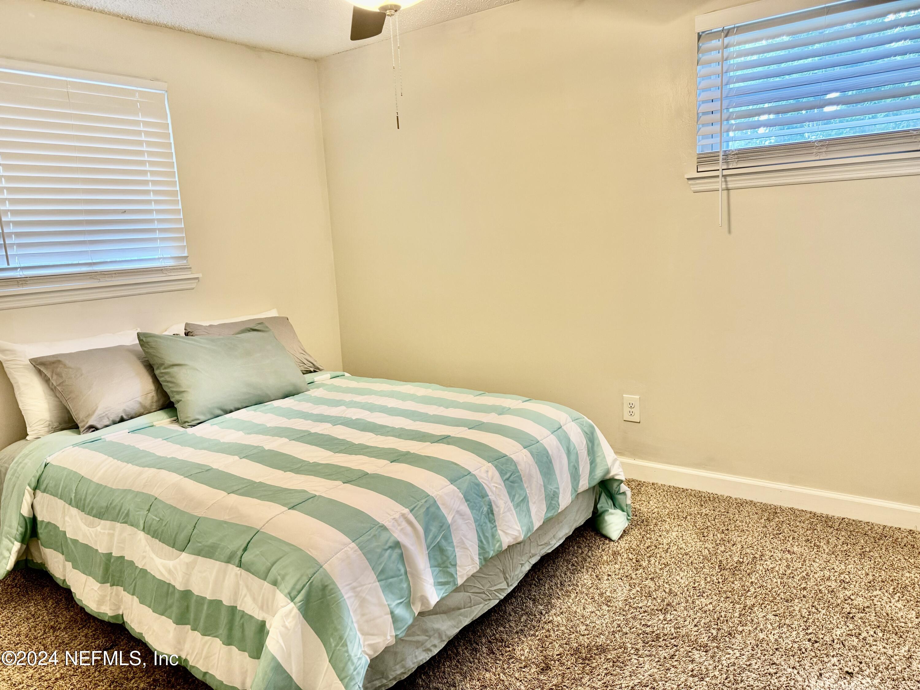 398 Gwinnett Road Orange Park, FL 32073 - Photo 30 of 40 a large bed sitting in a bedroom next to a window