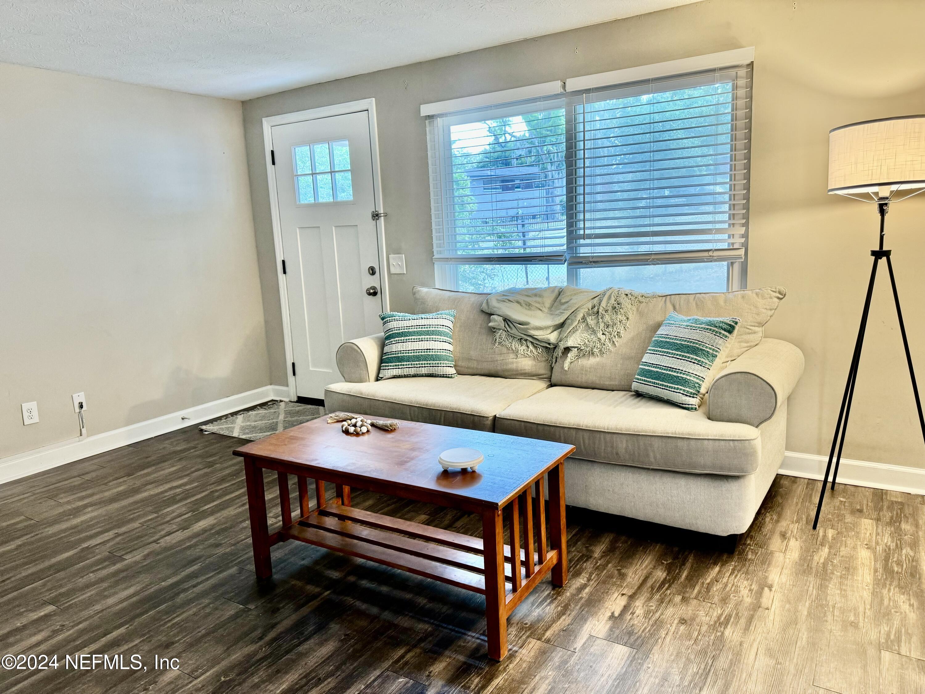 398 Gwinnett Road Orange Park, FL 32073 - Photo 3 of 40 a living room with furniture and a wooden floor