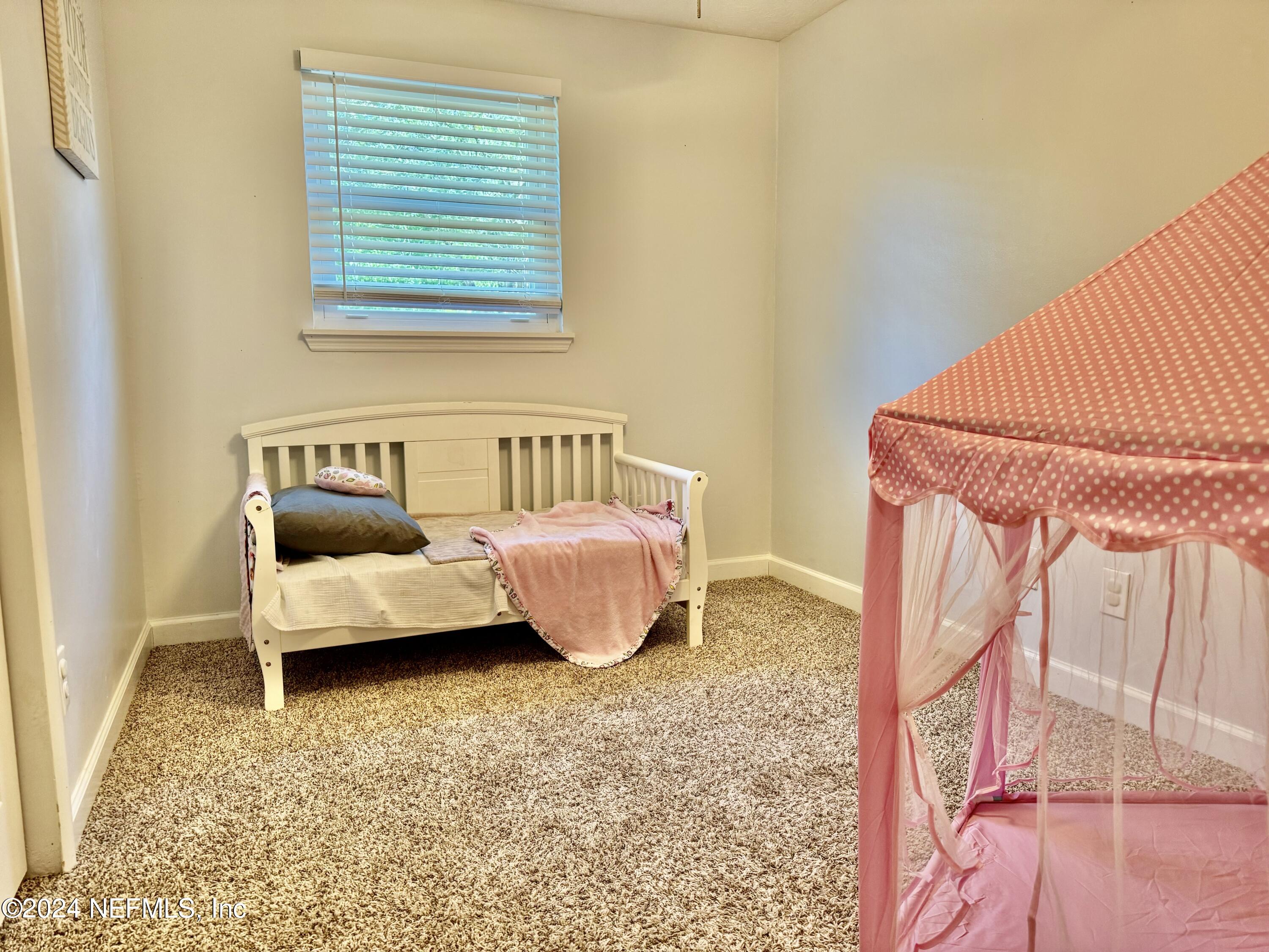 398 Gwinnett Road Orange Park, FL 32073 - Photo 31 of 40 a bedroom with a bed and a couch