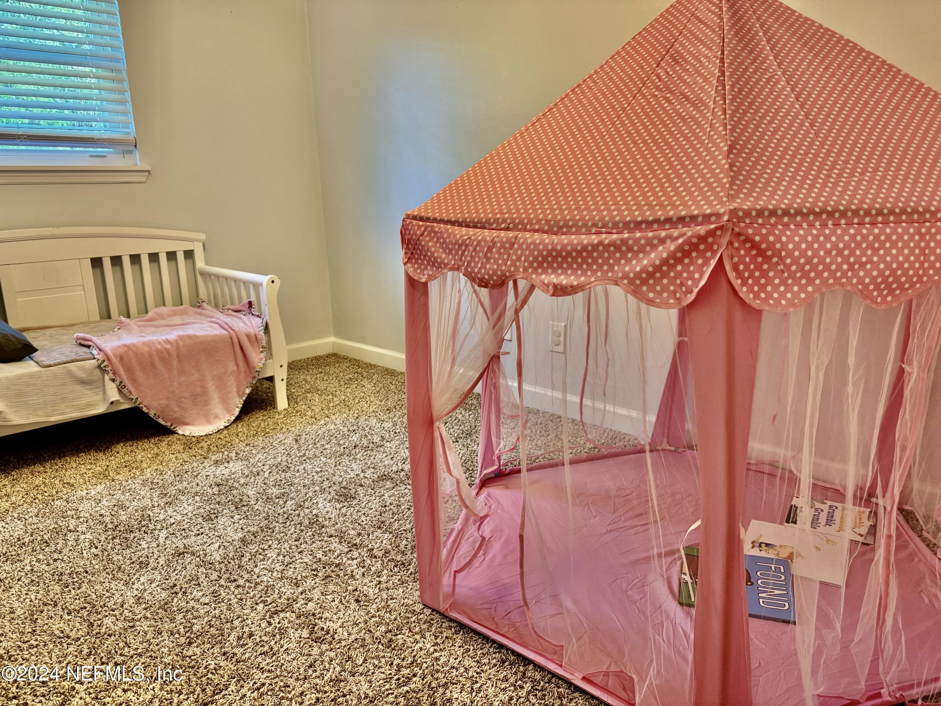 398 Gwinnett Road Orange Park, FL 32073 - Photo 33 of 40 a bedroom with a bed and a window