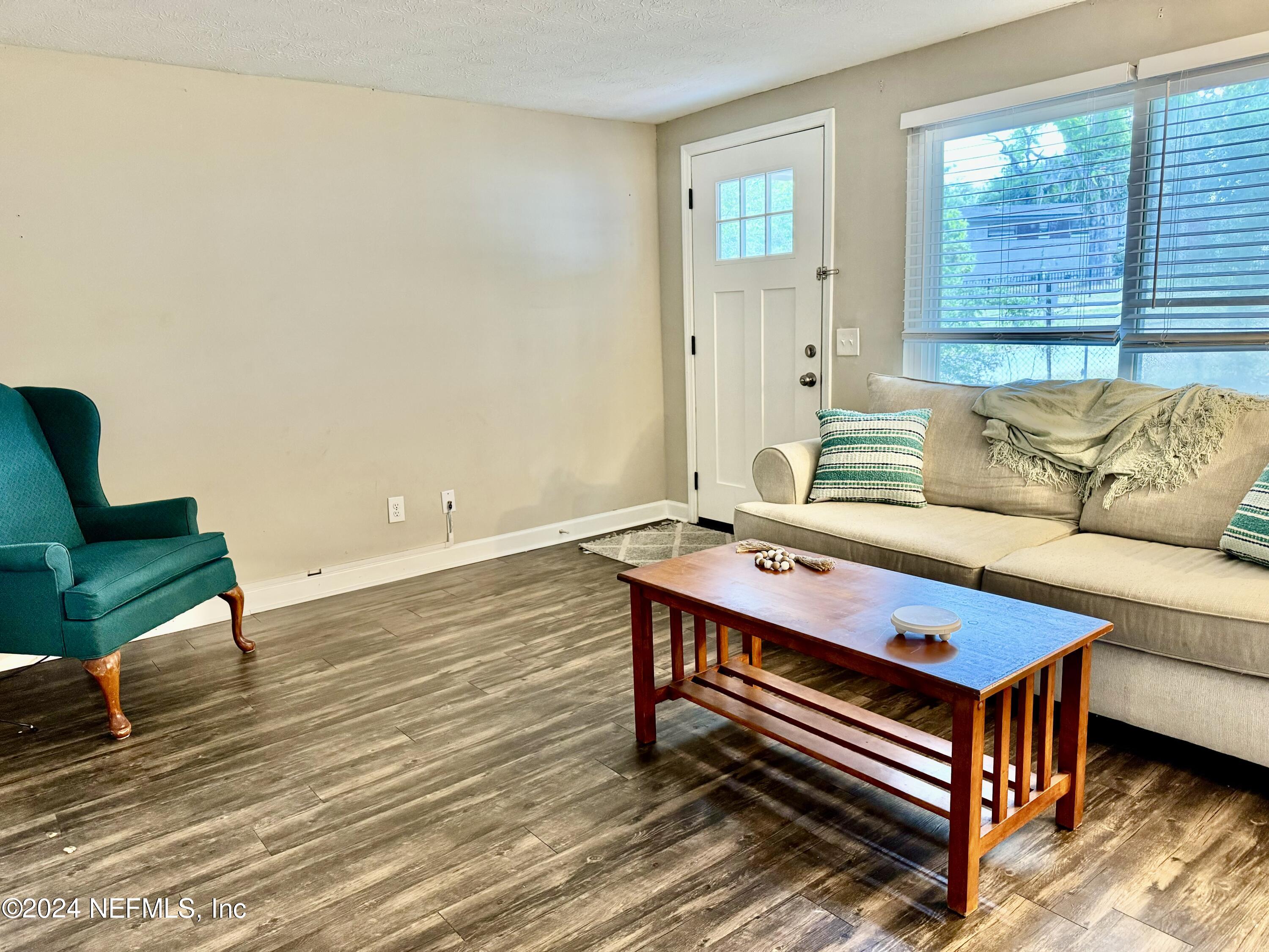 398 Gwinnett Road Orange Park, FL 32073 - Photo 4 of 40 a living room with furniture and a wooden floor
