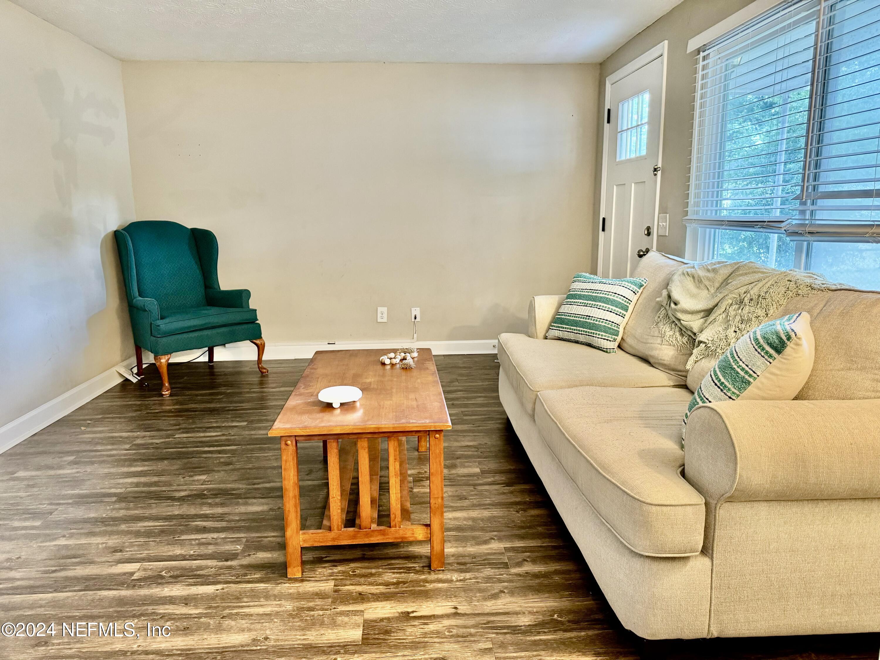 398 Gwinnett Road Orange Park, FL 32073 - Photo 6 of 40 a living room with a couch and a table