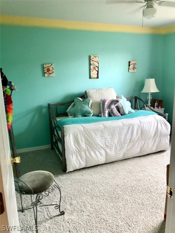 8133 Albatross Road Fort Myers, FL 33967 - Photo 11 of 14 a bedroom with a bed and a chair