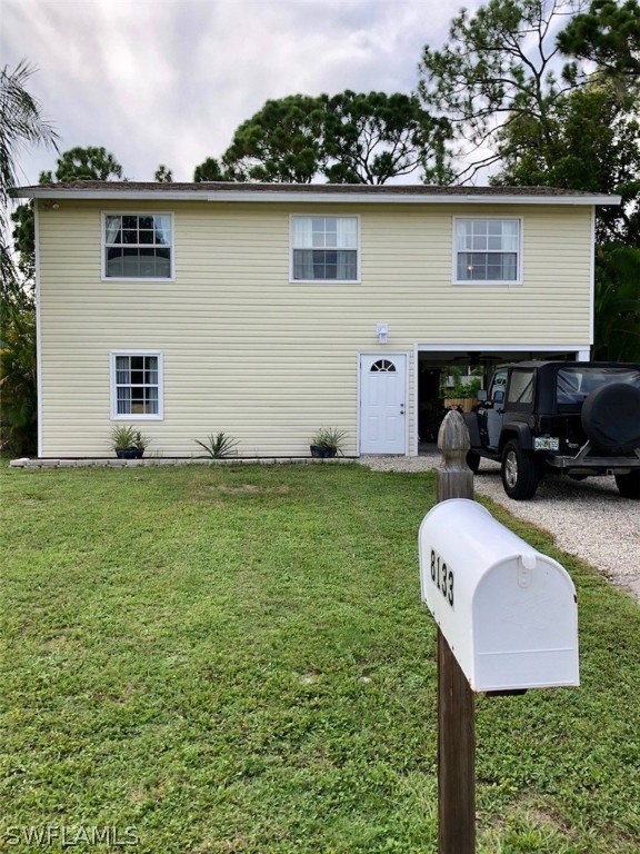 8133 Albatross Road Fort Myers, FL 33967 - Photo 2 of 14 a backyard of a house with table and chairs