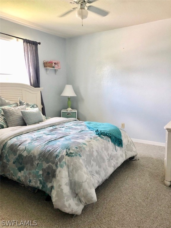 8133 Albatross Road Fort Myers, FL 33967 - Photo 7 of 14 a bedroom with a bed and window