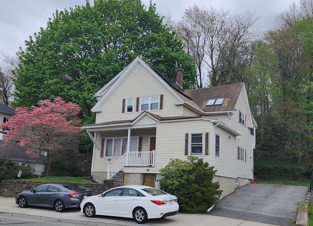 586 Franklin Street, Unit 2 Worcester, MA 01604 - Photo 1 of 7 a front view of a house with a garden