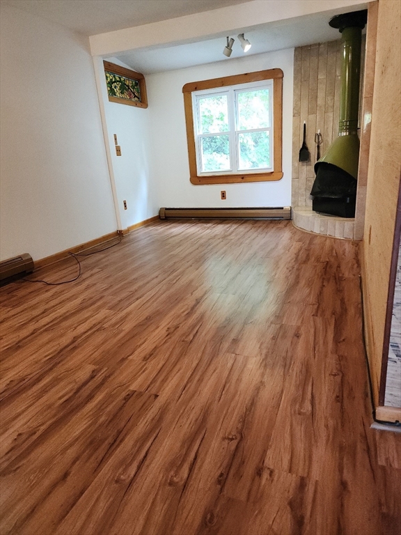 586 Franklin Street, Unit 2 Worcester, MA 01604 - Photo 4 of 7 an empty room with wooden floor and windows