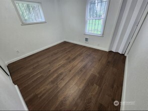 12524 Addison Street Southwest Lakewood, WA 98499 - Photo 15 of 20 a view of an empty room with wooden floor and a window
