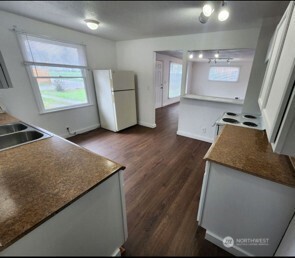 12524 Addison Street Southwest Lakewood, WA 98499 - Photo 16 of 20 a view of a kitchen with wooden floor and a sink