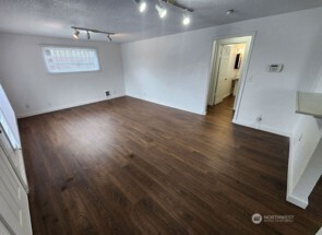 12524 Addison Street Southwest Lakewood, WA 98499 - Photo 19 of 20 an empty room with wooden floor and windows