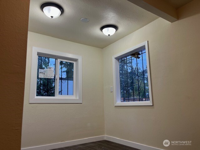 12524 Addison Street Southwest Lakewood, WA 98499 - Photo 5 of 20 an empty room with windows