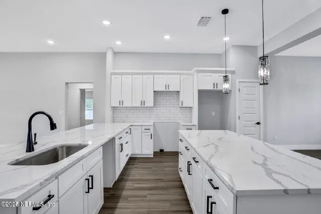 a kitchen with a sink stove and refrigerator