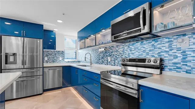 a kitchen with stainless steel appliances granite countertop a stove microwave sink and refrigerator