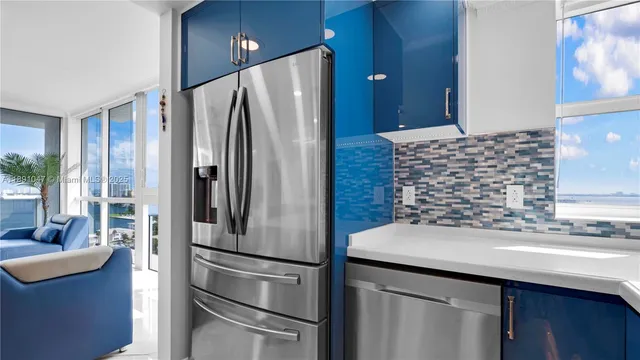 a kitchen with stainless steel appliances granite countertop a refrigerator and a sink