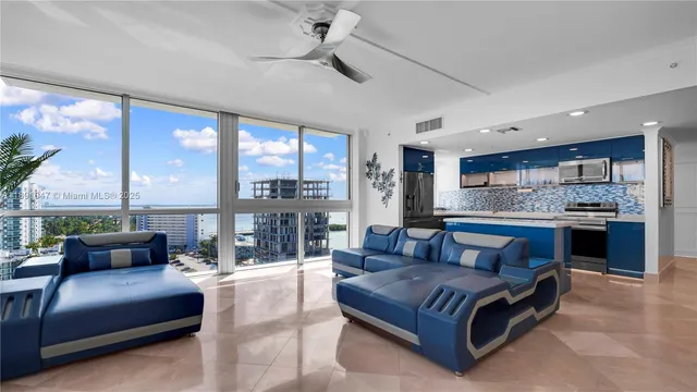 a living room with kitchen island furniture and a large window