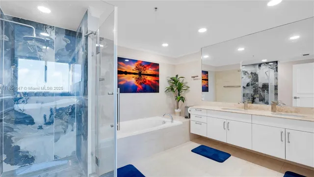 a spacious bathroom with a sink a mirror a bathtub and a shower