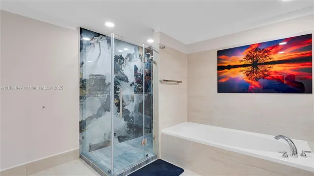 a bathroom with a glass shower door