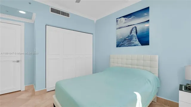 a bedroom with a bed and a painting