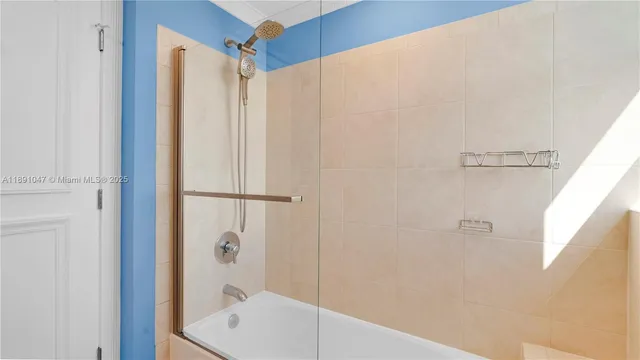 a bathroom with a shower and a sink