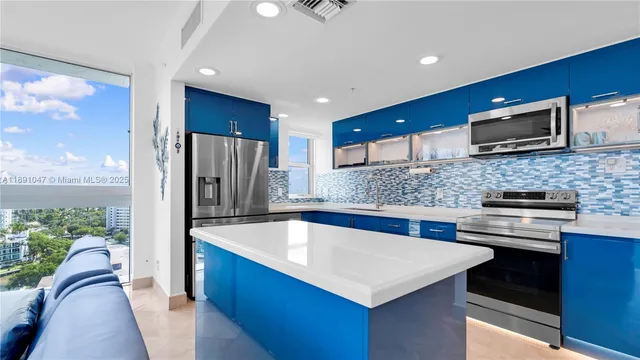 a kitchen with stainless steel appliances a sink stove and refrigerator