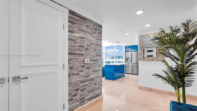 a view of kitchen with livingroom and natural light