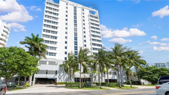 a view of a tall building next to a road