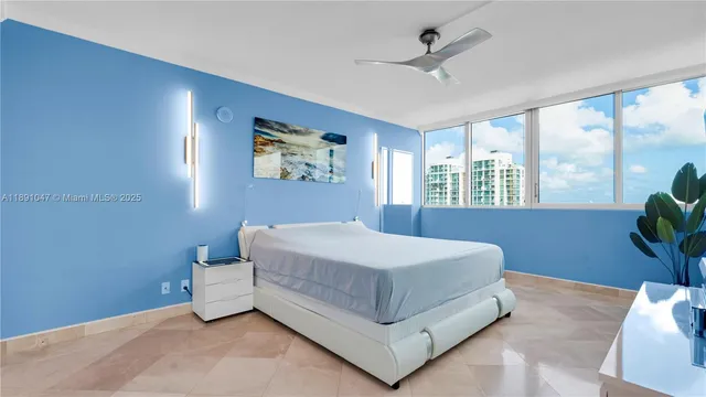 a bedroom with a bed and a painting on the wall