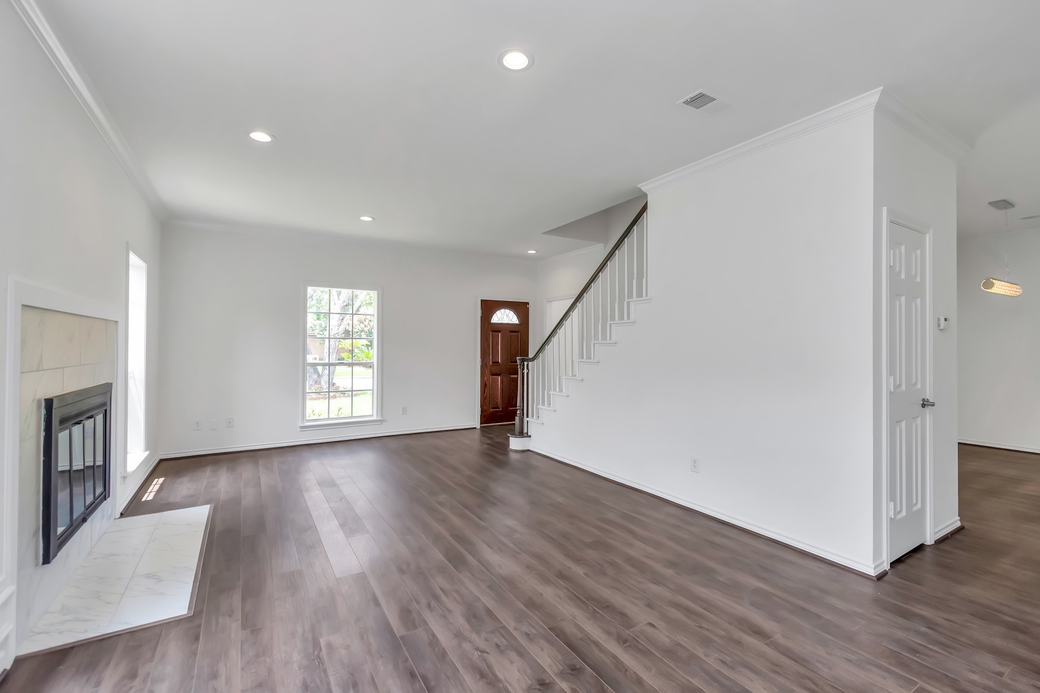 12818 Chamberlain Drive Houston, TX 77077 - Photo 12 of 32 an empty room with wooden floor and a window