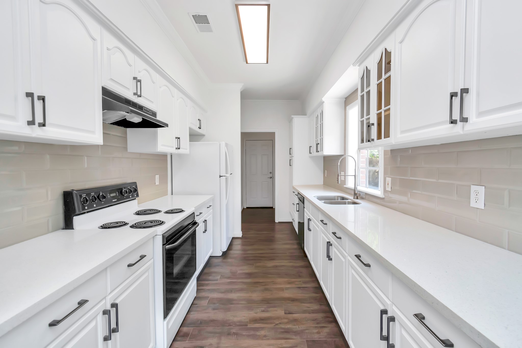 12818 Chamberlain Drive Houston, TX 77077 - Photo 16 of 32 a kitchen with stainless steel appliances a sink stove and cabinets