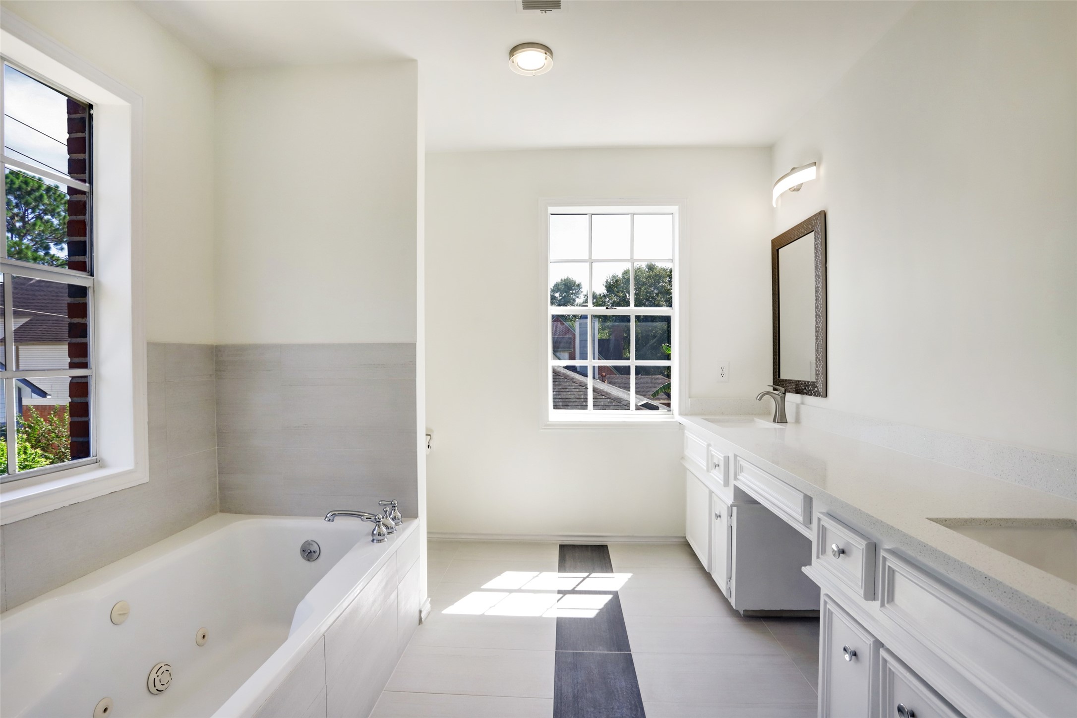 12818 Chamberlain Drive Houston, TX 77077 - Photo 21 of 32 a bathroom with a bathtub sink and mirror
